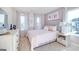 Comfortable bedroom featuring soft pink accents, lots of natural light, and stylish decor at 1678 Lacebark Elm Way, Lawrenceville, GA 30045
