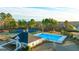 Aerial view of community pool and tennis courts surrounded by mature trees at 1678 Lacebark Elm Way, Lawrenceville, GA 30045