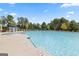 Large community pool with plenty of lounge chairs surrounding it at 1678 Lacebark Elm Way, Lawrenceville, GA 30045