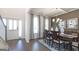 Formal dining room featuring hardwood floors, a stylish chandelier, and natural light at 1678 Lacebark Elm Way, Lawrenceville, GA 30045