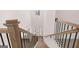 View from the top of the stairs to the entryway showcasing the hardwood floors and a chandelier in the foyer at 1678 Lacebark Elm Way, Lawrenceville, GA 30045