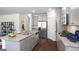 Well-lit kitchen with granite countertops, stainless steel appliances, hardwood floors, and ample storage space at 1678 Lacebark Elm Way, Lawrenceville, GA 30045