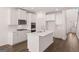Modern kitchen with white cabinets, stainless steel appliances, and a central island at 1678 Lacebark Elm Way, Lawrenceville, GA 30045