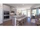 Modern kitchen featuring granite countertops, stainless steel appliances, a central island, and ample cabinet space at 1678 Lacebark Elm Way, Lawrenceville, GA 30045