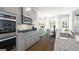 Charming kitchen featuring granite countertops, stainless steel appliances, hardwood floors, and plenty of natural light at 1678 Lacebark Elm Way, Lawrenceville, GA 30045