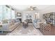 Spacious living room with neutral tones, ceiling fan, decorative fireplace and ample seating at 1678 Lacebark Elm Way, Lawrenceville, GA 30045