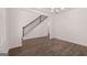 Open-concept space with stairs, hardwood flooring and elegant chandelier at 1678 Lacebark Elm Way, Lawrenceville, GA 30045