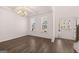 Bright living room featuring hardwood floors, large windows, and an elegant chandelier at 1678 Lacebark Elm Way, Lawrenceville, GA 30045