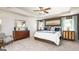 Comfortable main bedroom with tray ceiling, neutral walls, carpet, and natural light streaming from the windows at 1678 Lacebark Elm Way, Lawrenceville, GA 30045
