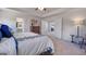 Comfortable main bedroom with neutral walls, carpet, and light streaming from adjacent rooms at 1678 Lacebark Elm Way, Lawrenceville, GA 30045