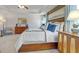 Comfortable main bedroom with natural light streaming from the windows and a wooden frame bed at 1678 Lacebark Elm Way, Lawrenceville, GA 30045