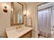 Elegant bathroom with quartz countertop, bronze fixtures, and a large mirror at 2118 Town Manor Ct, Dacula, GA 30019