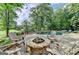 Stone fire pit with comfortable seating and pool view at 2118 Town Manor Ct, Dacula, GA 30019