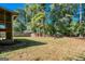 Landscaped backyard, partially fenced with mature trees and storage shed at 6671 Pelica Ct, Riverdale, GA 30274