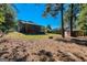 Expansive backyard with mature trees and wooden storage shed at 6671 Pelica Ct, Riverdale, GA 30274