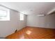 Basement featuring tile flooring, bright windows, and ductless air conditioning at 6671 Pelica Ct, Riverdale, GA 30274