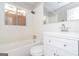 Bathroom features white vanity, toilet and tiled bathtub at 6671 Pelica Ct, Riverdale, GA 30274