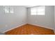 A bright bedroom features tile flooring and natural light from two windows at 6671 Pelica Ct, Riverdale, GA 30274