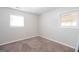 Bedroom with neutral carpet and two windows at 6671 Pelica Ct, Riverdale, GA 30274