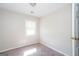 This bedroom offers neutral walls, carpet, and a window for natural light at 6671 Pelica Ct, Riverdale, GA 30274