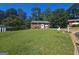 View of a well-kept lawn and a charming red brick home with a neatly landscaped front yard at 6671 Pelica Ct, Riverdale, GA 30274