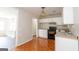Bright kitchen with white cabinets, black appliances, and granite-look countertops at 6671 Pelica Ct, Riverdale, GA 30274