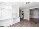 Living room featuring wood-look floors, built-in shelves, and views to other rooms at 6671 Pelica Ct, Riverdale, GA 30274