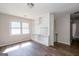 Bright living room features wood-look floors, and built-in shelving at 6671 Pelica Ct, Riverdale, GA 30274
