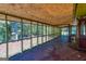 Large screened porch with wood ceiling and views of backyard and mature trees at 6671 Pelica Ct, Riverdale, GA 30274