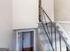 Stairwell with dark railing and grey painted stairs leading to a landing with doorways at 6671 Pelica Ct, Riverdale, GA 30274