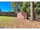 Storage shed in fenced backyard offers extra outdoor storage at 6671 Pelica Ct, Riverdale, GA 30274