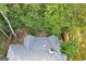 Aerial view of the house highlighting the roof, back deck, and surrounding mature trees for privacy at 3192 Creek W Trce, Powder Springs, GA 30127