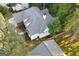 A beautiful aerial view of the home highlighting the roof and landscaped yard at 3192 Creek W Trce, Powder Springs, GA 30127