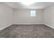 Bedroom features neutral carpeting, base trim and one light-filled window at 3192 Creek W Trce, Powder Springs, GA 30127