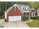 Charming brick home featuring an attached two-car garage, manicured landscaping, and inviting front porch at 3192 Creek W Trce, Powder Springs, GA 30127