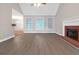 View of the living room featuring modern floors, a fireplace, and plenty of light at 3192 Creek W Trce, Powder Springs, GA 30127