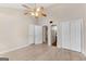 Spacious bedroom with laminate floors, ceiling fan, and double doors to closets at 4234 Stillwater Dr, Duluth, GA 30096