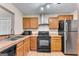 Kitchen with wood cabinets and stainless steel appliances at 4234 Stillwater Dr, Duluth, GA 30096