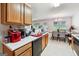 Kitchen with wood cabinets, appliances, and dining area at 695 Shadow Lake Dr, Lithonia, GA 30058