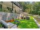 Landscaped backyard with artificial turf and seating area at 3946 Paces Ferry Nw Rd, Atlanta, GA 30327