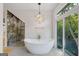 Modern bathroom with a soaking tub, glass shower, and marble accents at 3946 Paces Ferry Nw Rd, Atlanta, GA 30327