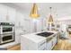 Modern kitchen with white cabinetry, marble countertops, and gold accents at 3946 Paces Ferry Nw Rd, Atlanta, GA 30327