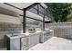 Outdoor kitchen with grill, pizza oven, and refrigerator at 3946 Paces Ferry Nw Rd, Atlanta, GA 30327