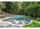 Modern pool with built in seating and lush landscaping at 3946 Paces Ferry Nw Rd, Atlanta, GA 30327