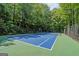 Private tennis court nestled in a wooded area at 3946 Paces Ferry Nw Rd, Atlanta, GA 30327