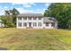 Classic two-story home boasting a symmetrical facade, black shutters, and a spacious front lawn at 330 N Fayette Dr, Fayetteville, GA 30214