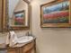 Powder room with ornate mirror, vanity, and framed artwork at 2554 Emerald Dr, Jonesboro, GA 30236