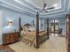 Main bedroom with a large four-poster bed, ceiling fan, and hardwood floors at 2554 Emerald Dr, Jonesboro, GA 30236