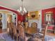 Formal dining room with a large wooden table and ornate chandelier at 2554 Emerald Dr, Jonesboro, GA 30236