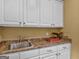 Functional laundry room with stainless steel sink and ample storage at 2554 Emerald Dr, Jonesboro, GA 30236